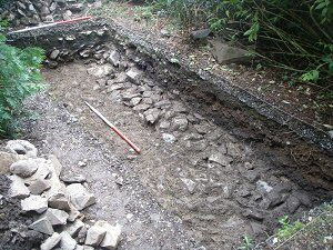 Trench showing the late 18th Century road foundation17th Century retaining wall foundation